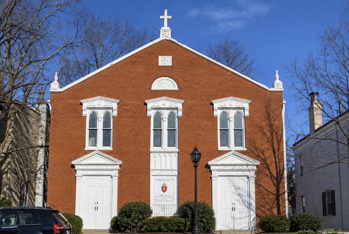 Historic red brick church with white-trimmed doors